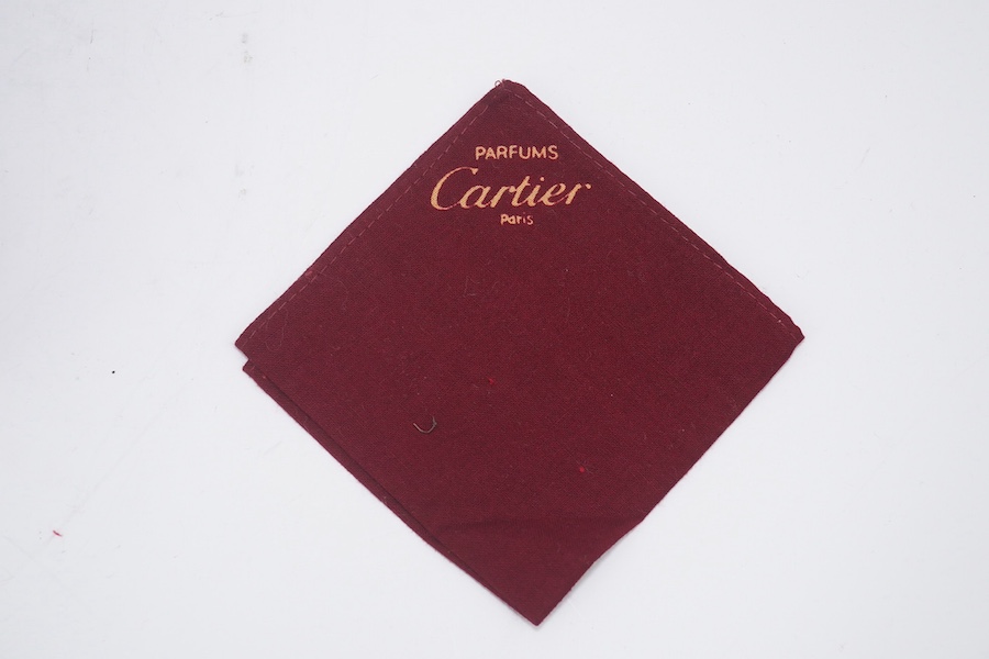 An assortment of Must de Cartier bordeaux leather accessories